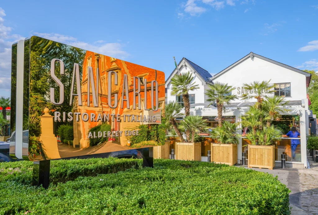 San Carlo Alderley Edge restaurant signage with live palms in pots to exterior supplied by I want plants