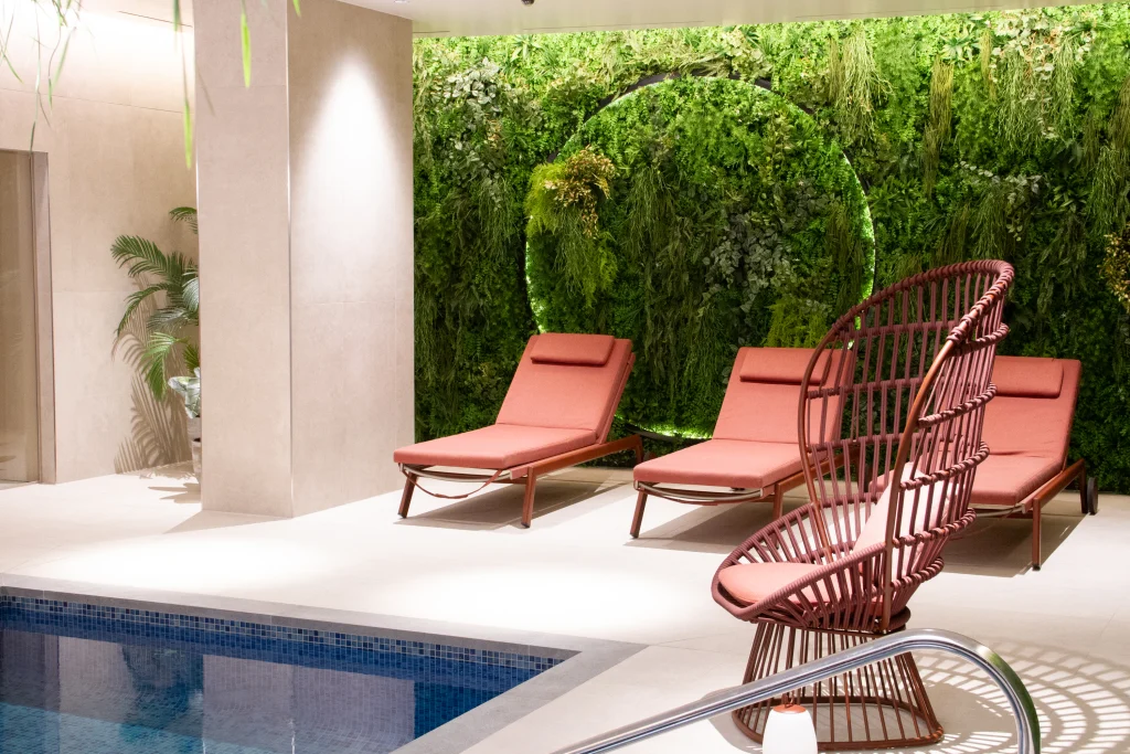 indoor swimming pool with artificial living wall back drop by i want plants