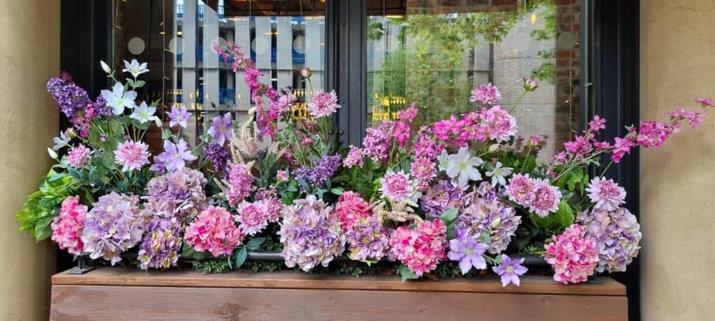 All Bar One Chambord custom installation of Hydrangeas, Chrysanthemums, Clematis and Pink Delphiniums and Lilacs