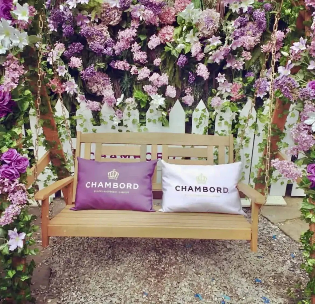 Hydrangeas, Chrysanthemums, Clematis and Pink Delphiniums and Lilacs framing the Chambord swing at All Bar One Chester