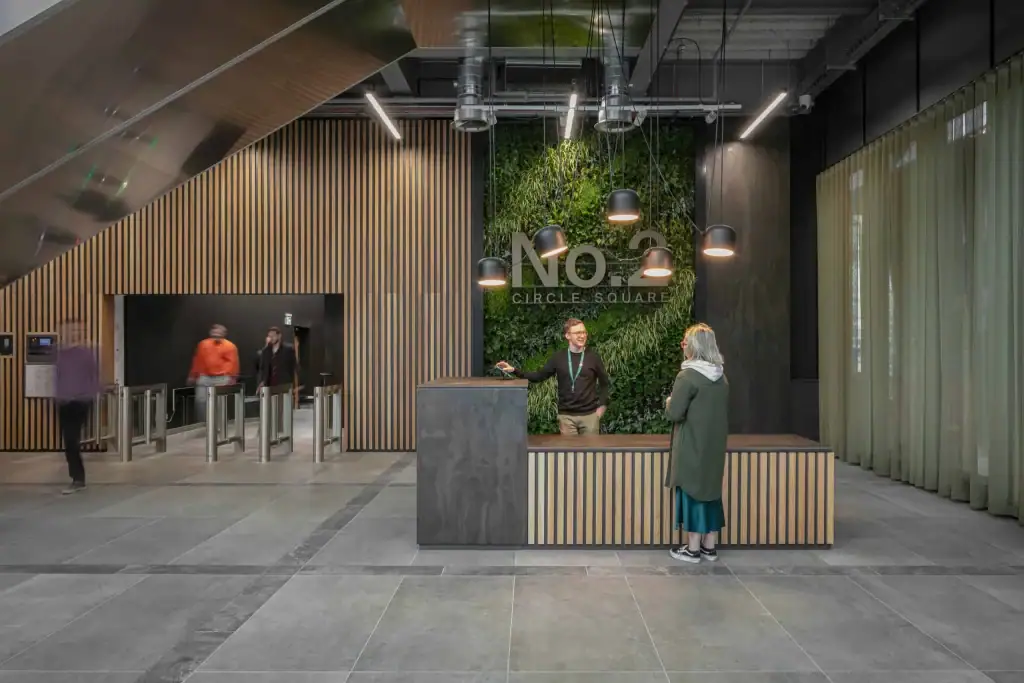 reception area at no 2 circle square with hyvert living wall behind the reception desk