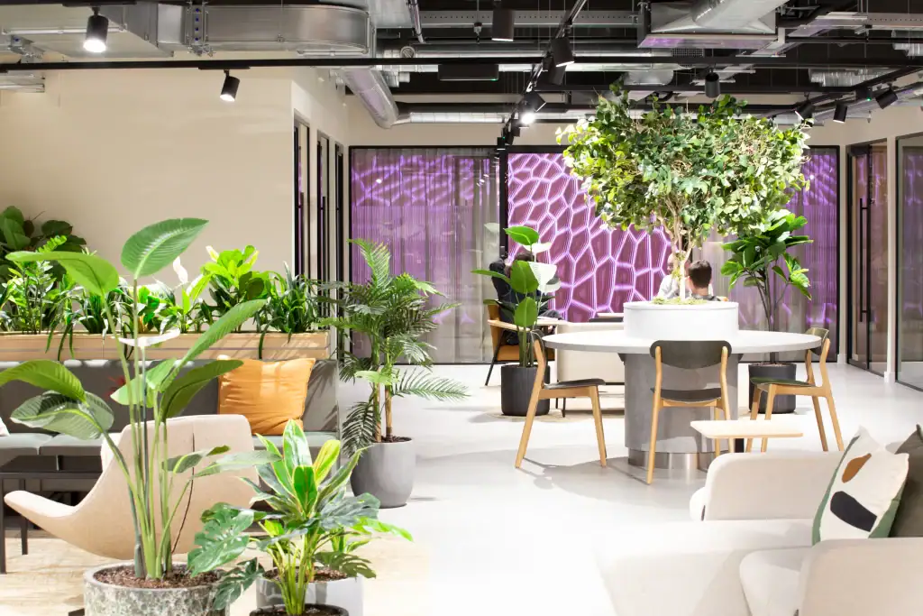 Artificial office plants adding greenery to an open-plan office space.