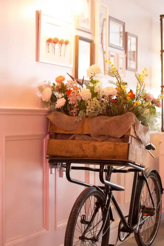 Mixed artificial flowers displayed on a vintage bike at The Florist