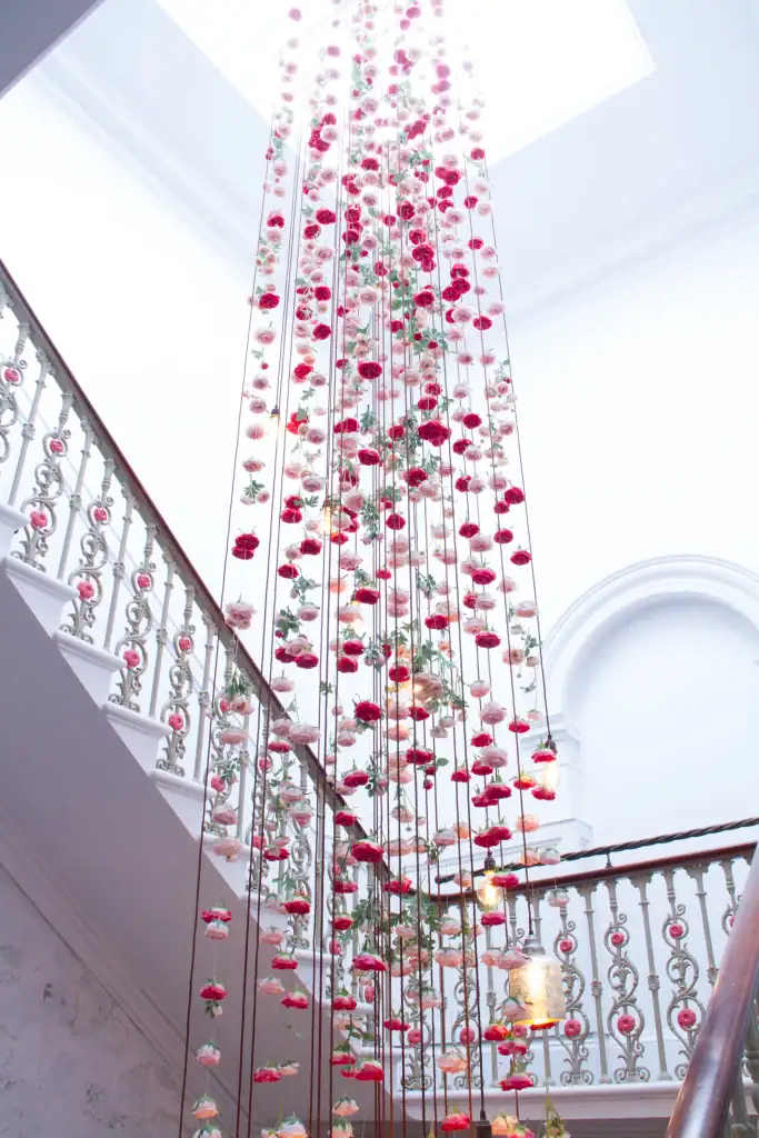 Cascading artificial roses down staircase at The Florist