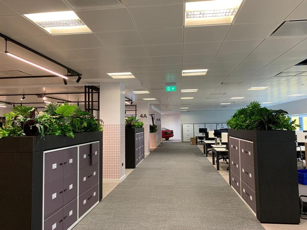 Live plants in custom built troughs on workspace cupboards