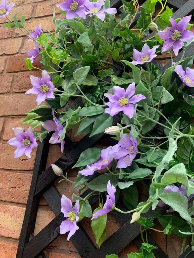 Artificial purple Clematis on trellis