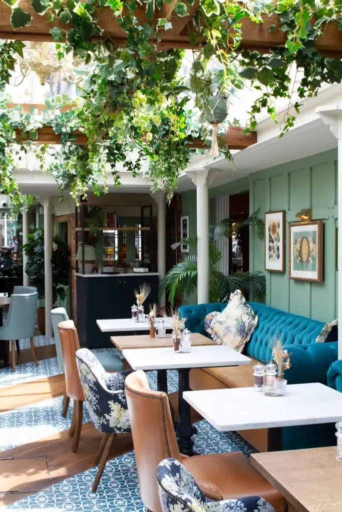 TheBull Henley dining area with ceiling suspended ivy foliage by I Want Plants