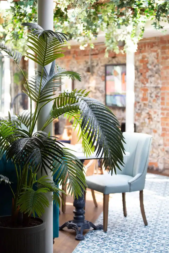 TheBull Henley dining area with ceiling suspended artifical ivy foliage and artificial plants in pots by by I Want Plants