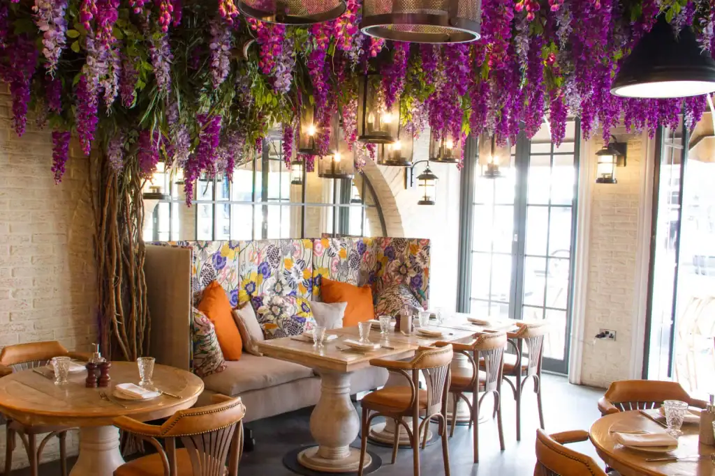 Hanging plant display above dining tables at Victors