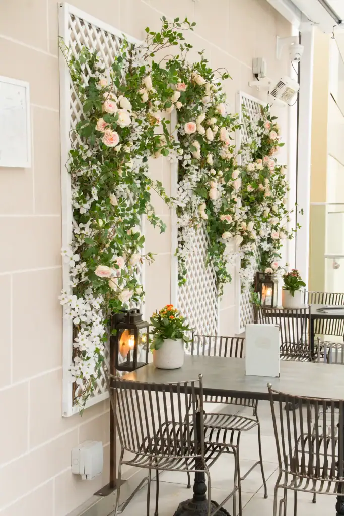 trellis with artificial flower display by i want plants