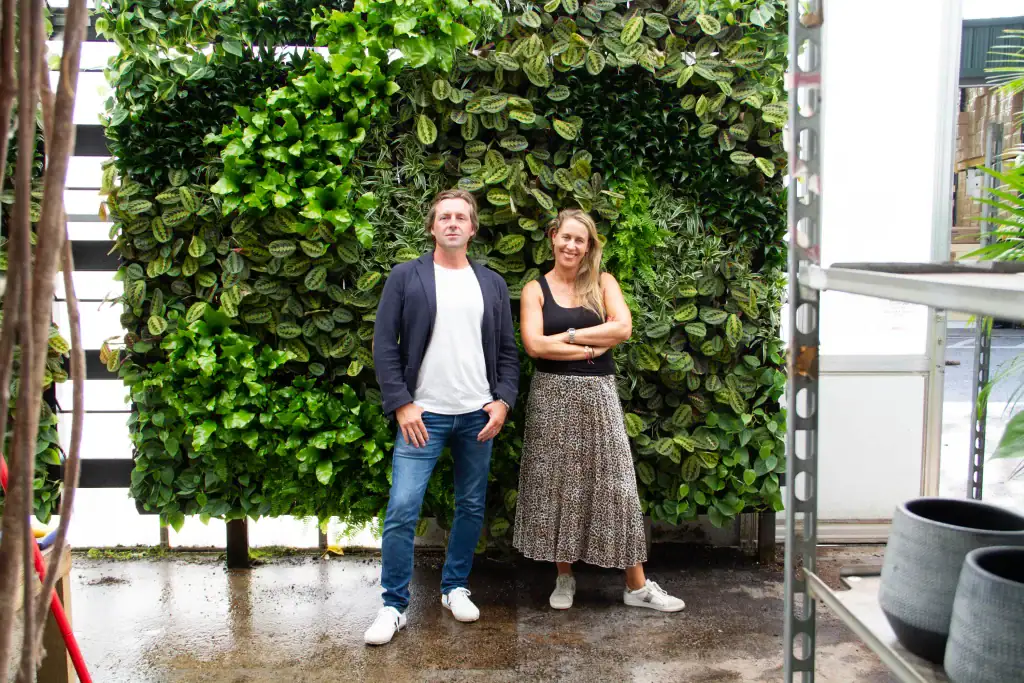 I Want Plants Directors Richard and Jessica Rowlands standing in front of infant HYVERT living wall