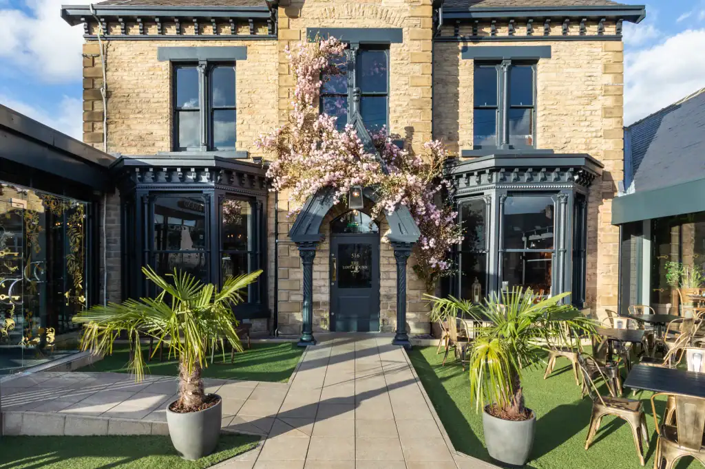 Custom made blossom archway around Lost & Found Sheffield