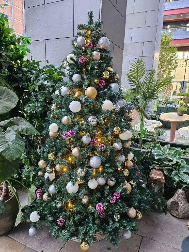 artificial custom made tree with pink pine cones and gold silver and white baubles by i want plants