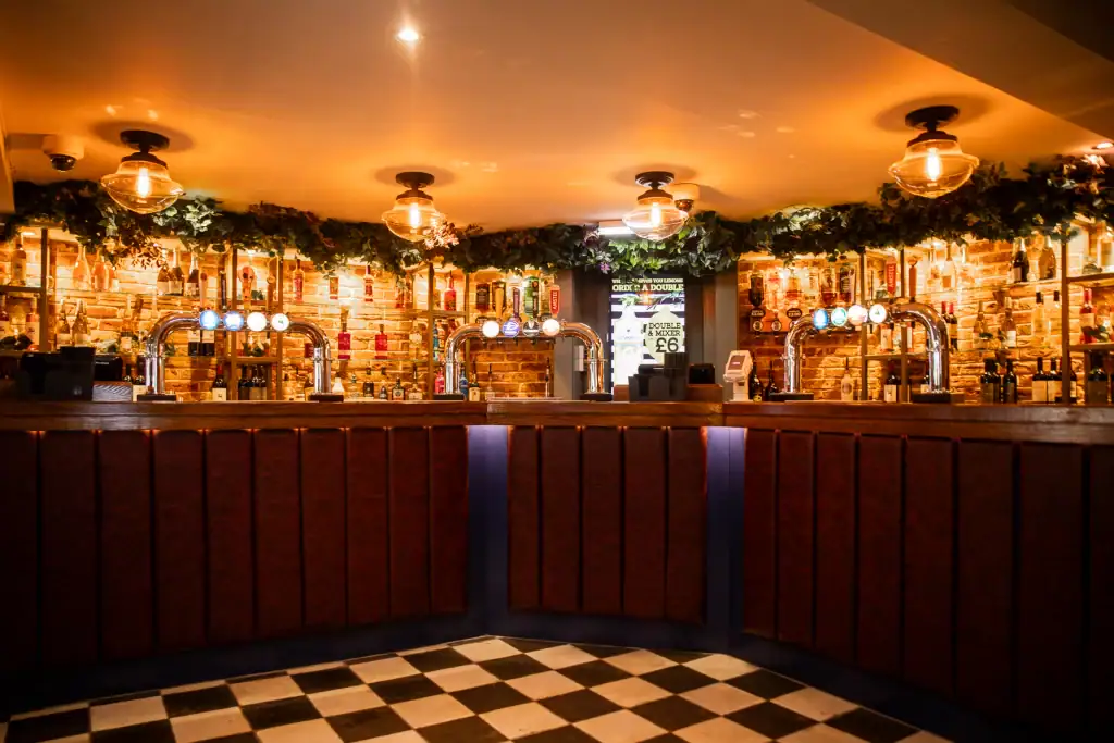 artificial foliage above bar optics by I want plants