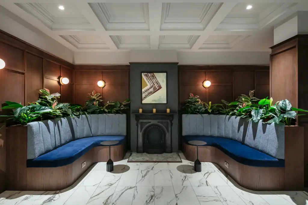 Bruntwood Bond artificial plants in built in troughs behind curved seating