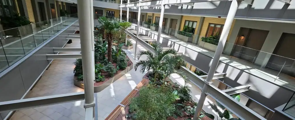 looking down at the communal atrium with live planting displays at Horlicks Quarter