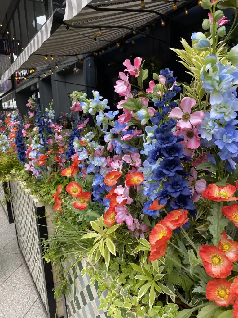 flight club artificial floral displays in client containers
