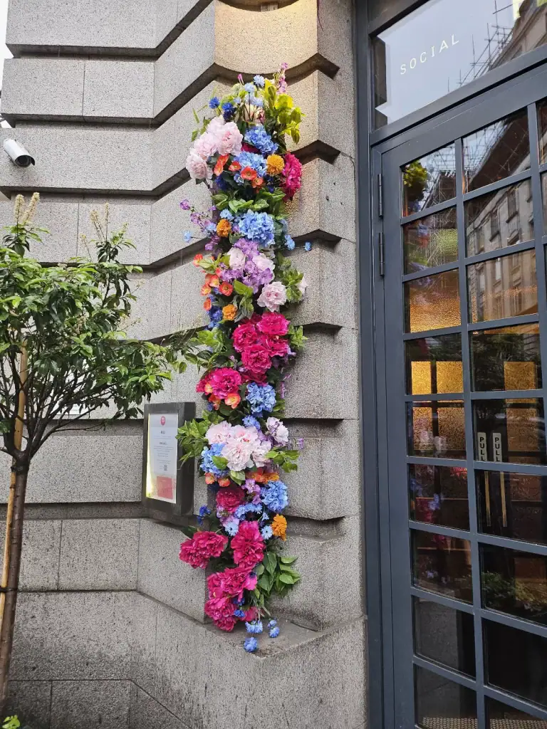 Flight Club artificial floral display next to entrance