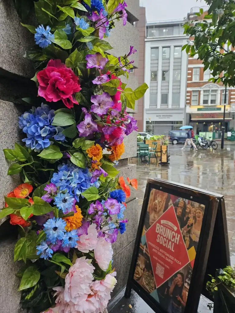 Flight Club artificial floral display next to entrance