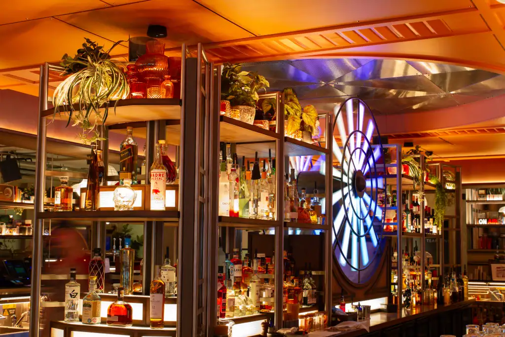 central spirits bar at electric shuffle manchester decorated with artificial plants by i want plants