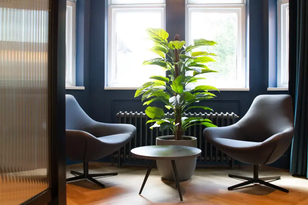 artificial plant in container from i want plants, positioned next to radiator at South @Cheadle Royal workspace