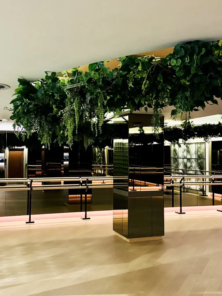 wellness and yoga area at West Village with circular, trailing artificial plants installation