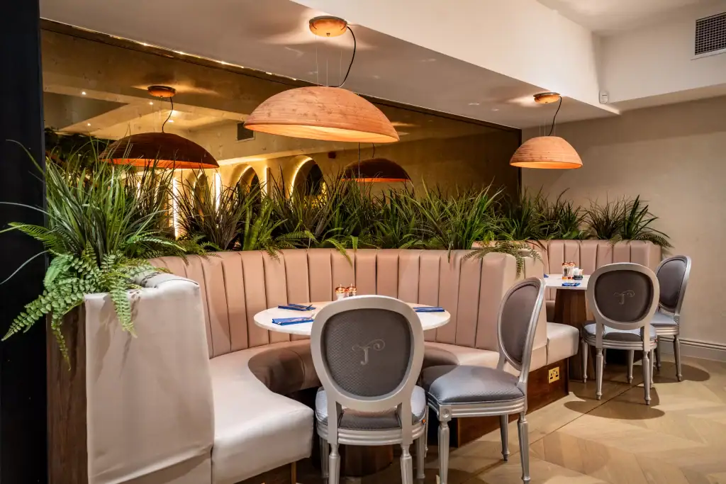 artificial grasses built into booth seating by i want plants