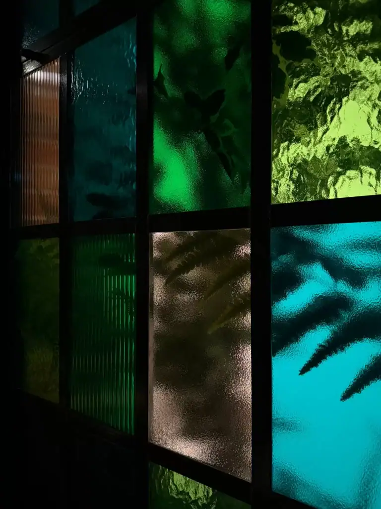 lighting and plants concealed behind colour glass windows