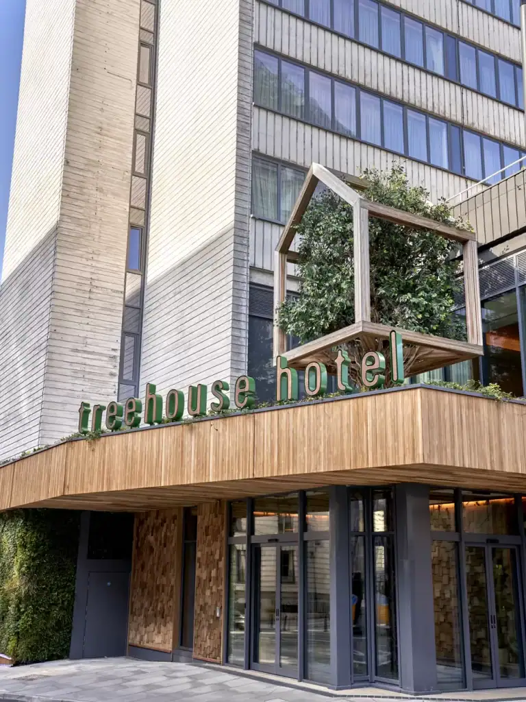 Treehouse Hotel exterior with custom made tree and HYVERT living wall by I Want Plants
