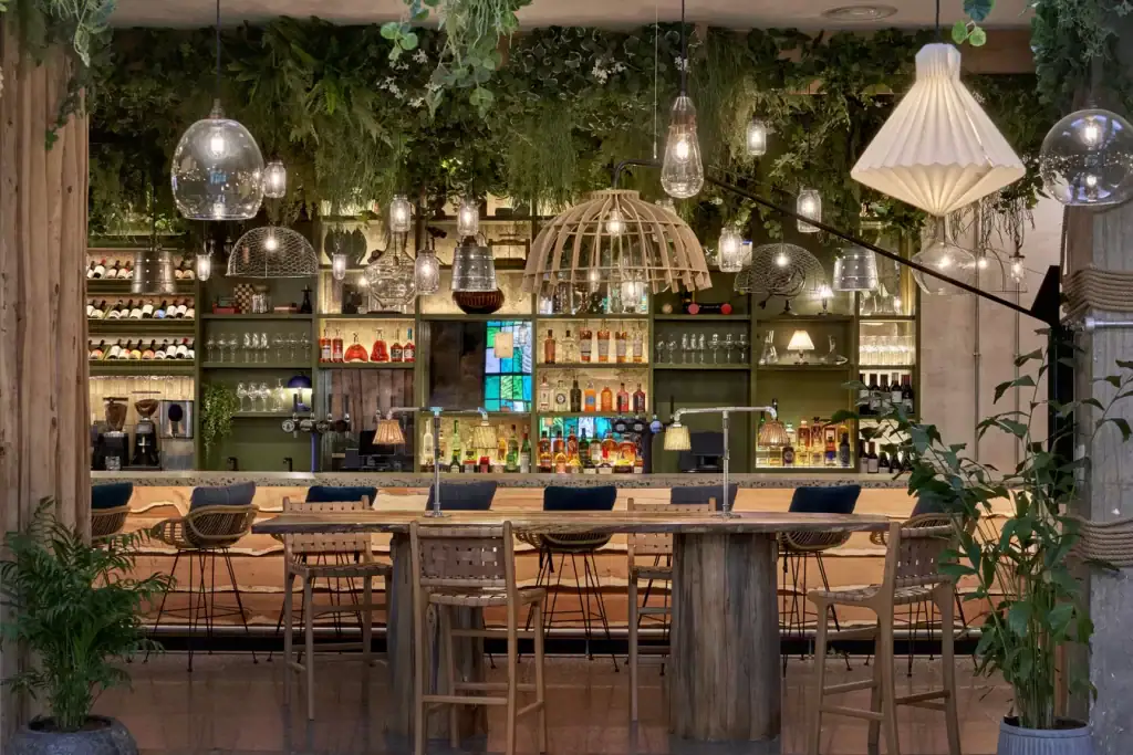 Treehouse Hotel Manchester bar area with trailing replica plants