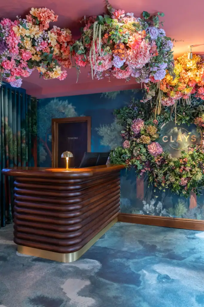 Clays Soho entrance with artificial floral installations by I Want Plants