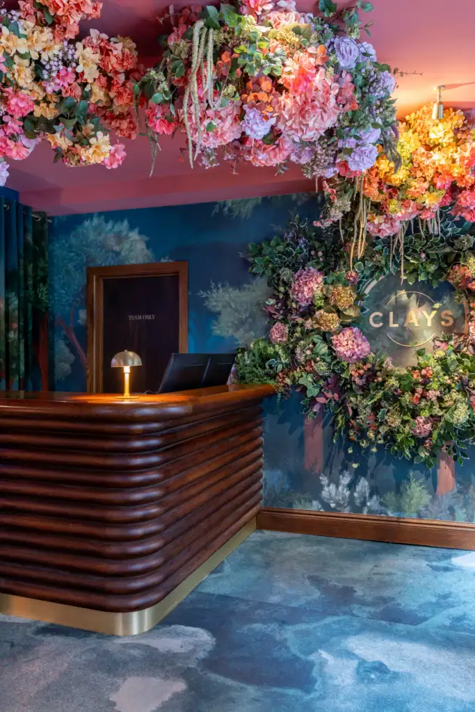 Clays Soho entrance with artificial floral installations by I Want Plants