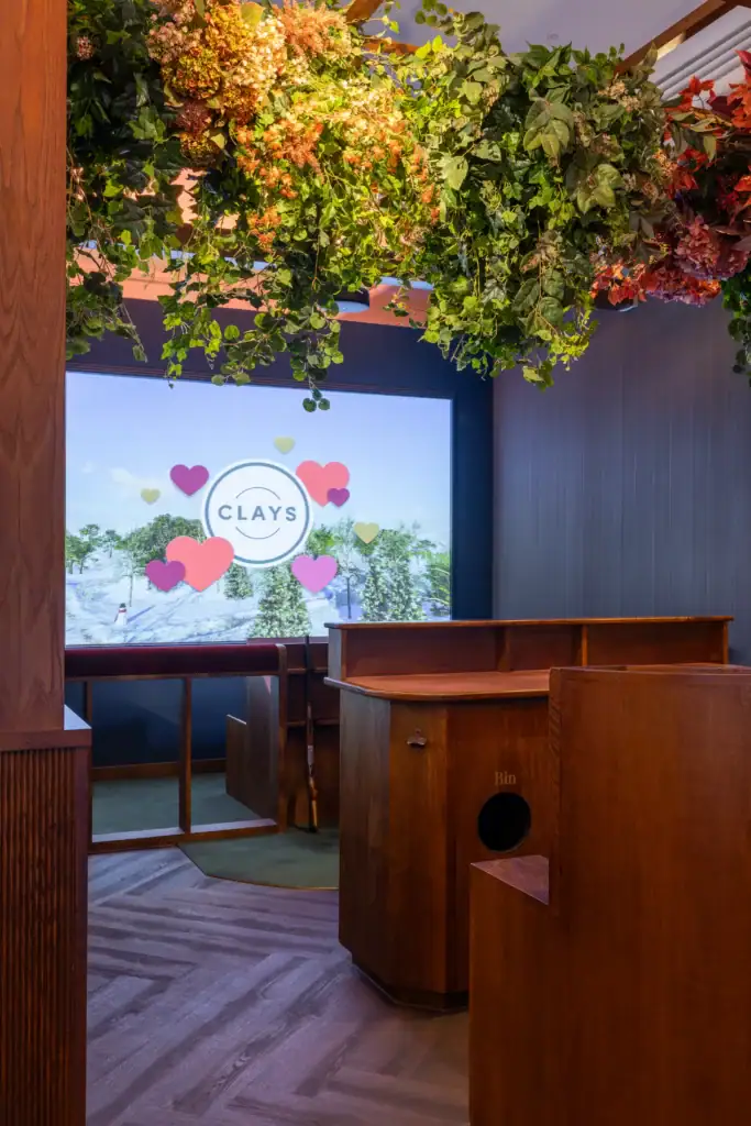 Clays Soho Gaming Pens with ceiling suspended artificial flowers